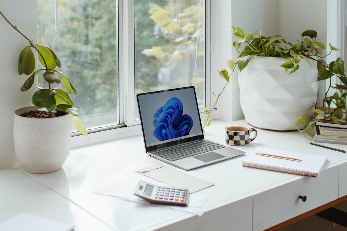 Small business receipts, calculator, and packaging supplies used to estimate Etsy seller fees and costs